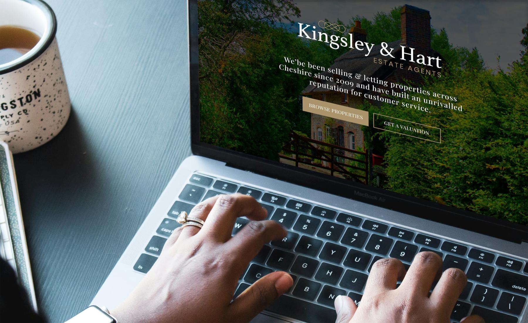 Laptop displaying the homepage of an estate agent website
