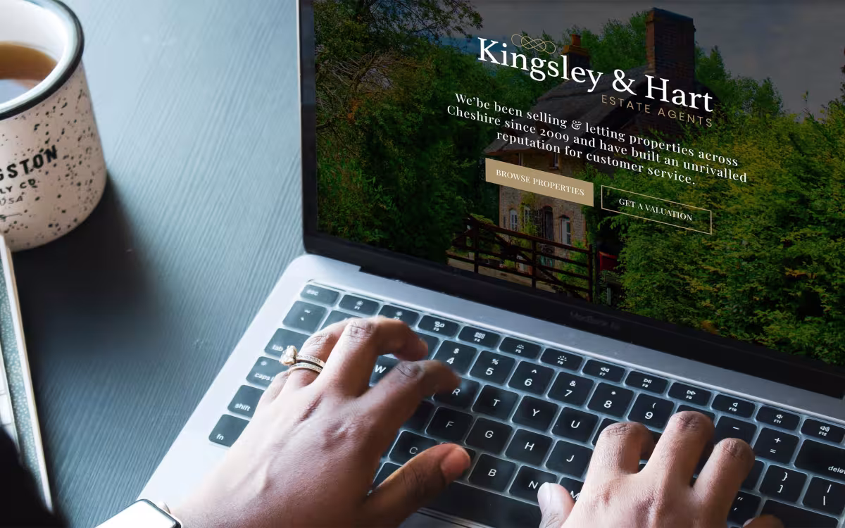 Laptop displaying the homepage of an estate agent website